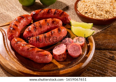 Grilled sausage. Grilled Sausage on wooden board. Brazilian barbecue.