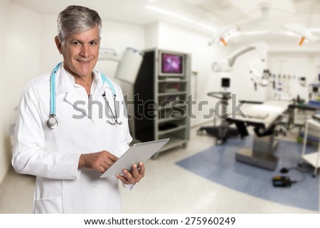 healthcare, technology and medicine concept - smiling doctor with tablet in hospital