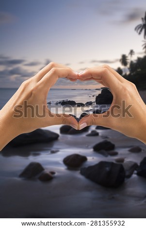 woman making heart with his hand in several places in the world