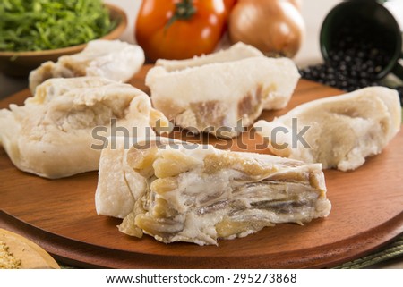 Raw pig tails on wooden background