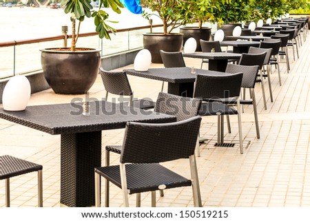 black empty table beside chao praya river, bangkok, thailand