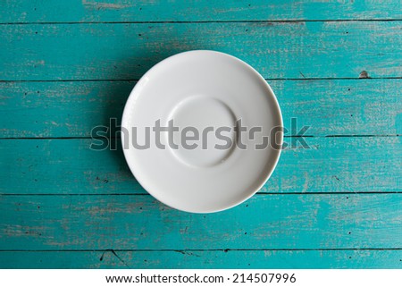 White plate on grunge blue wood table