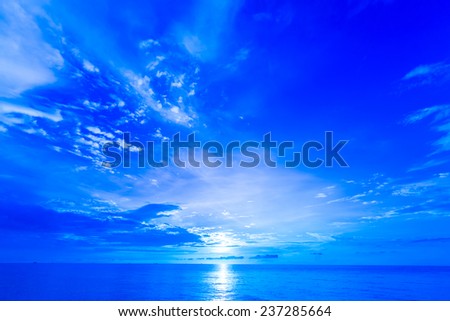 Beautiful sunrise over ocean. Deep blue filter.