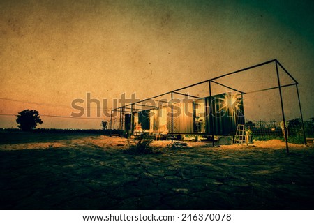 Vintage of container cabin home with twilight sky. Retro filter. and Grunge paper filter.