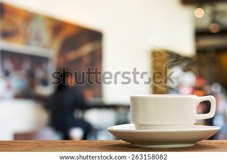 Hot espresso on the table with people do meeting business plan in coffee shop background