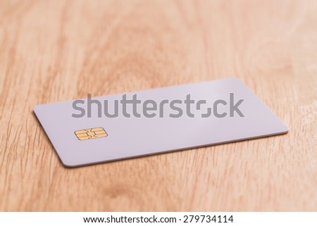 White blank credit card on wood board.