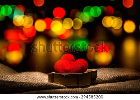 Valentine day background. Red two hearts in chest box on bokeh light background.