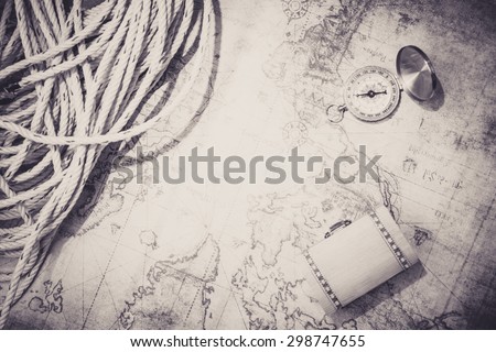Compass and rope and treasure chase vintage map. Retro filter