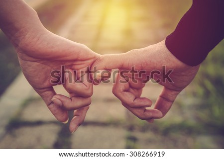 Photo of Valentine day background. Happy couple holding hands together as forever love. Vintage filter.