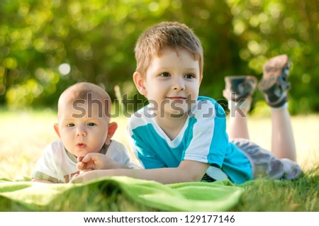 The two brothers are the grass in the park