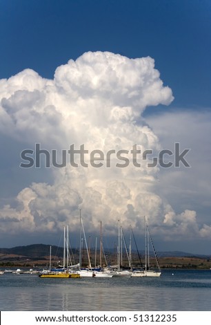 Skies and clouds. Beautiful white cloud above the sea. Talamone, Tuscany, Italy.