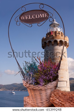 Travel, Italy - Welcome flowers basket above the sea of Portoferraio, Elba Island.