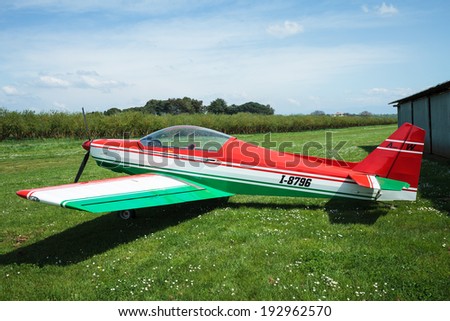 SUTRI, LAZIO, ITALY - APRIL 6, 2014: Asso IV Whisky  ultralight aircraft with nice design of Italian flag, at La Valicella airfield. Asso Whisky IV is a tandem two seat, low wing homebuilt aircraft.