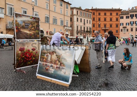 ROME, ITALY - JUNE 18, 2014: Painters trying to sell their paintings and tourists watching, in Piazza Navona, Rome, Italy. Piazza Navona is one of the most famous places in Rome.