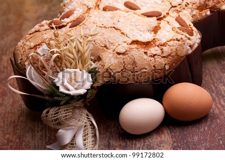 Traditional Italian desserts for Easter - Closeup of Easter dove and eggs, on wood table.