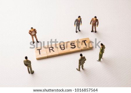 Miniature figures businessman : meeting on trust word by wooden block letters on white paper background, in concept of business and corporation Foto d'archivio © 