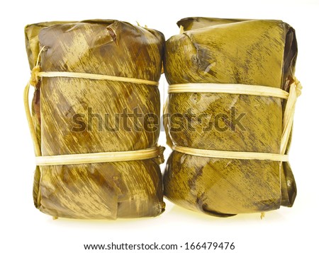 dual pack of Khao Tom Mat on white background. Khao Tom Mat is thai dessert. it make from sticky-rice sugar banana and wrap in banana leaf. final is cooked with steam