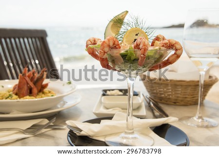 View of a meal in sea shore restaurant with sea in a background.