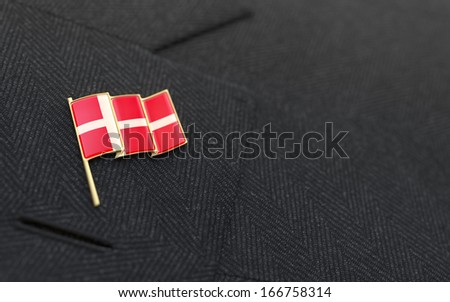 Denmark flag lapel pin on the collar of a business suit jacket shows patriotism