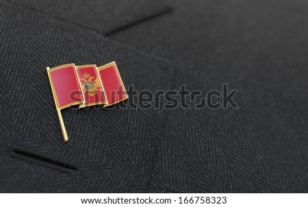 Montenegro flag lapel pin on the collar of a business suit jacket shows patriotism