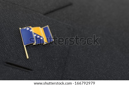 Bosnia and Herzegovina flag lapel pin on the collar of a business suit jacket shows patriotism