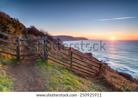 Beautiful sunrise on the South West Coast Path at Pencarrow Head looking out to Lantivet Bay on the south coast of Cornwall