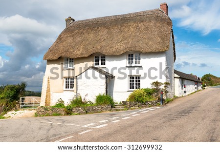 A traditional thatched cottage on the Roseland Peninsula in Cornwall
