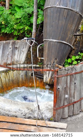 wooden tub for carpet washing under a stream of water