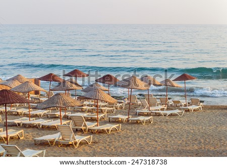 Just a simple beach with funny old-style umbrellas and cheap plastic deck chairs