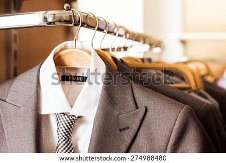 Mens suits on hangers in a clothes store