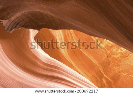 Sunlight reflected off of the red rock curves of the Antelope Canyon Slot Canyons in Page, Arizona.  This shot was taken in Lower Antelope Canyon.   Antelope Canyon was carved by flash floods.