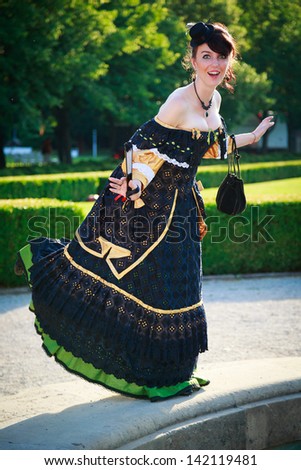 Young girl in a historical dress funny posing