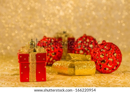 Christmas decorations: Red Christmas ornaments, golden ribbon and Christmas decoration on golden background