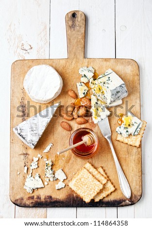 Assortment of various types of cheese on wooden board