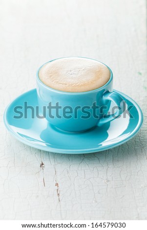 Cappuccino coffee in blue coffee cup