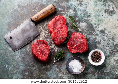Raw fresh marbled meat Steak, seasonings and meat cleaver on metal background