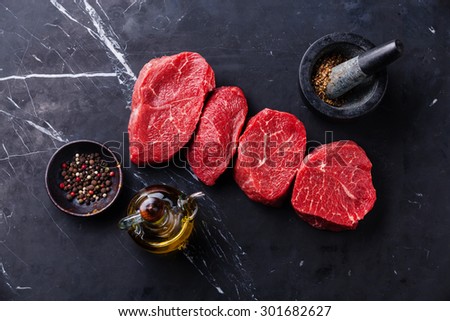 Raw fresh marbled meat Steak and seasonings on dark marble background