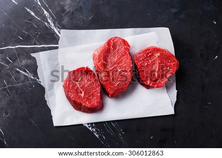 Raw fresh marbled meat Steak on dark marble background