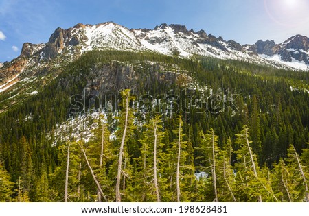 The North Cascade Mountains. Highway 20 in Washington state travels over Washington Pass and Rainy Pass through deep valleys and gorgeous mountain peaks. Also called the North Cascades Highway.