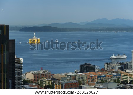 Off Shore Oil Rig. Tug boats escort an off shore oil drilling rigs as it leaves Seattle, Washington to return to Alaska.