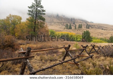 Autumn Countryside. A split rail fence and a grove of Aspen trees make for a beautiful scenic countryside scene near Winthrop, Washington, USA.