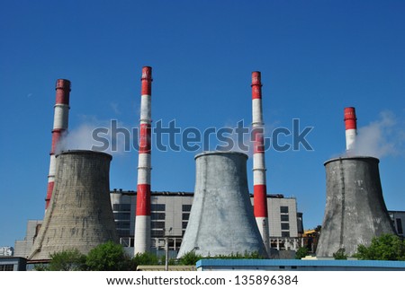 Smoking chimneys power plants and railway station on the blue background