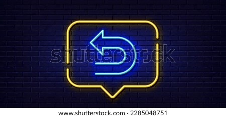 Neon light speech bubble. Undo arrow line icon. Left turn direction symbol. Navigation pointer sign. Neon light background. Undo glow line. Brick wall banner. Vector
