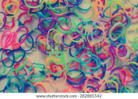 Photo texture of small round colorful rubber bands for making rainbow loom bracelets