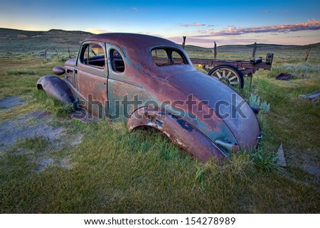 Abandoned car in field at dawn, Bodie Ghost Town, California.