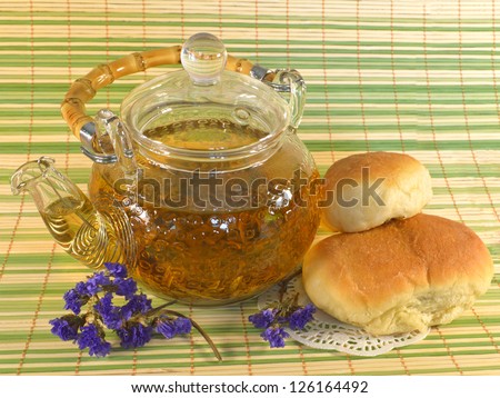 Teapot with stuffed buns and purple flowers