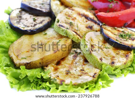 Vegetables barbecue with grilled marks, roasted slices of potatoes, eggplants and zucchini, food still life, close up