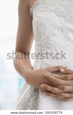 Bride\'s hands on stomach (focus on hands)