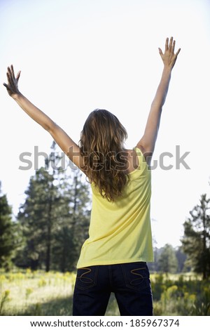 Young woman raising hands