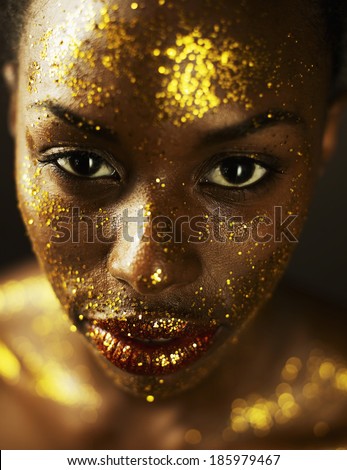 Young Woman Covered in Gold Leaf